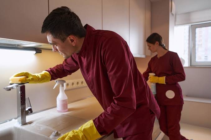 Kitchen sink and counters being cleaned